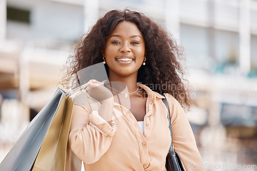 Image of Shopping bag, happy black woman portrait and city customer smile for discount sales, luxury fashion products and town market trip. Wealthy, rich and young consumer on vacation travel in Ibiza Spain