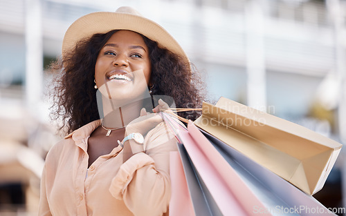 Image of Shopping bag, happy black woman and travel customer smile for discount sales, thinking of luxury fashion choice and market in summer. Wealthy, rich and smile consumer on vacation in Ibiza Spain city