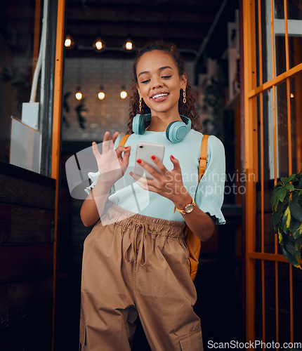 Image of Happy gen z young woman with smartphone, social media fashion influencer in trendy cafe and youth culture in Miami. .Trendy student communication, reading text on cell and 5g technology connection