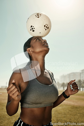 Image of Woman, soccer ball and balance on head in training grass field, sports ground or fitness training club. Football player, black woman and athlete in exercise practice with wellness goals or motivation