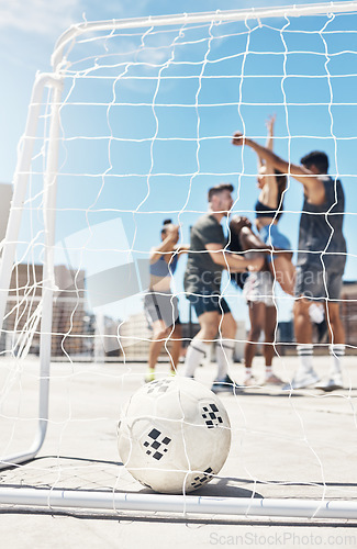 Image of Football, soccer team and ball in goal post or net with diversity sports group of men and women in celebration of win, winning and scoring on urban rooftop. Exercise, concrete training and champions