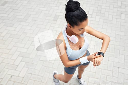 Image of Exercise, runner and black woman with digital smartwatch to track steps, calories counter or heart rate. Sports health, running monitor and fitness app to check wellness, training and workout support