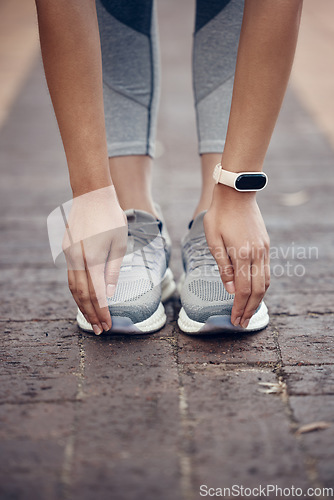 Image of Fitness, stretching and woman with shoes and toes touch with smartwatch for workout, health and sports training. Exercise, wellness and performance with hands of athlete for outdoor cardio lifestyle