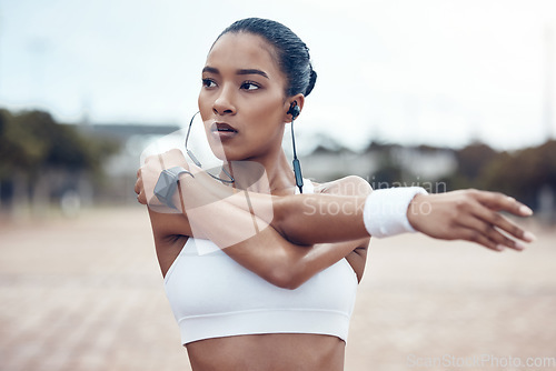 Image of Black woman, fitness and stretching, exercise and earphones, music and motivation for active lifestyle outdoors. African American, strong and focus, cardio and endurance, workout and healthy living.