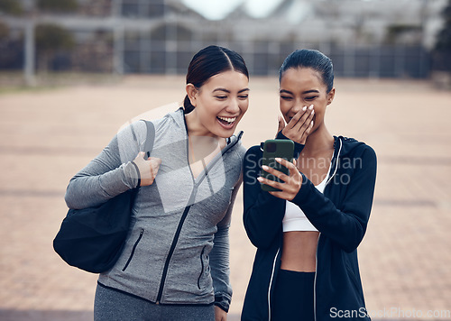 Image of Happy, phone and friends laughing at a funny online joke after a workout in a city together, cheerful, humour and carefree. Social media, internet and women sharing comedy meme or internet post