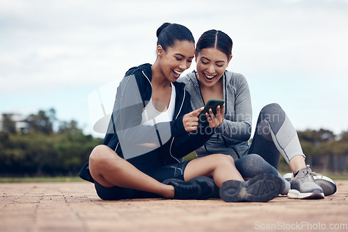 Image of Phone, happy and fitness friends on social media laughing at funny gossip, fake news and trending viral online content. Women, sports and healthy girls resting for training workout exercise outdoors