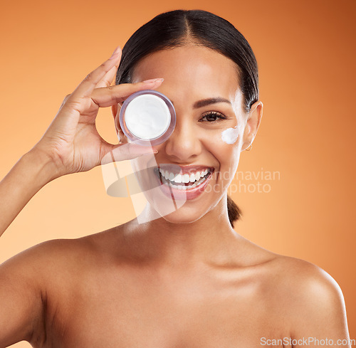 Image of Beauty, skincare and cream product by black woman in studio, happy, smile and relax during face hygiene, grooming and routine. Wellness, skin and dermatology with portrait of lady excited for facial