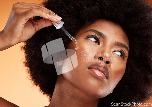 Image of Face serum, skincare and black woman using beauty oil product with pipette for skin. Wellness, afro and natural female model from Nigeria with a dermatology dropper for moisturizing facial treatment