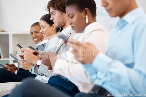 Image of Phone, conference and team in a row in the office sitting in a convention, seminar or tradeshow. Diversity, technology and group of business people networking on smartphone at a corporate workshop.