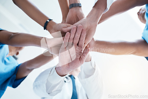 Image of Below, group and hands stack for medical, staff and teamwork in hospital for motivation. Team, doctor and nurse with hand for collaboration, healthcare and help in community at job together in clinic