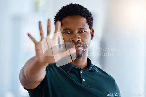 Image of Black man, hands and stop or five gesture for sign, warning or halt raising palm and fingers in protest. Portrait of a serious African American male showing number hand in vote, icon or voice