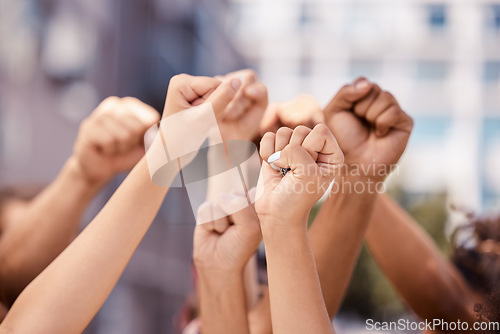 Image of Diversity, hands and fist in community protest for human rights, racism and equality in fight for justice in the city. Group hand of people in strike for economic or government change in a urban town