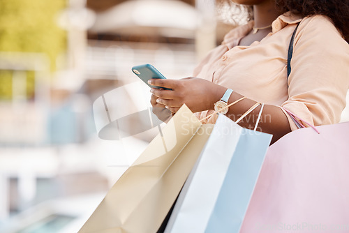 Image of Shopping bag, sale and smartphone with black woman, luxury boutique for customer and online purchase in city. African American female, phone and clothes from retail therapy spree for town market trip