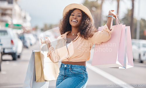Image of Fashion black woman with shopping bags in city or happy with sale, discount or luxury retail brands of clothes. Customer with smile, boutique products or designer gift form store or shopping mall
