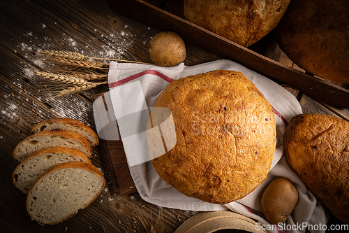 Image of Artisan whole and sliced sourdough bread