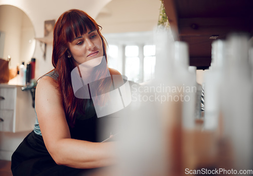 Image of Woman, salon and shelf smile with product, shampoo and stock at work in hair care, style and beauty. Small business owner, hairdresser and entrepreneur at job, shop or store with relaxer, oil or gel