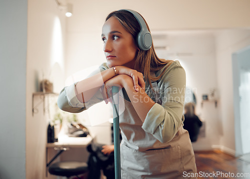 Image of Woman, cleaning and tired with music in headphones while cleaning room in home. Cleaner, thinking and contemplating while listening to radio, podcast or streaming with rest, exhausted and burnout