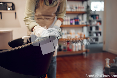 Image of Salon, small business and woman cleaning chair with equipment in modern beauty parlor in city. Cleaner, maid or girl washing furniture at hairdressing shop with hygiene and sanitizing products.