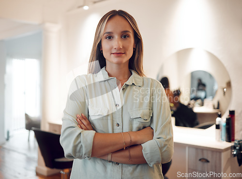 Image of Entrepreneur, woman and small business owner at hairdresser, beauty parlor or salon with confidence, pride and motivation for work or service. Portrait of female hair stylist with arms folded at work