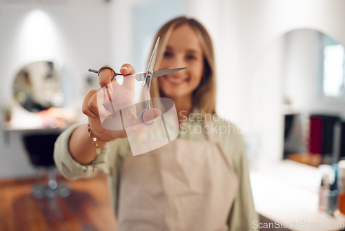 Image of Hand, scissors and haircut with a woman hairdresser ready to cut or style hair during a hairdressing appointment. Salon, beauty and haircare with a female at work in a salon for fashion or style