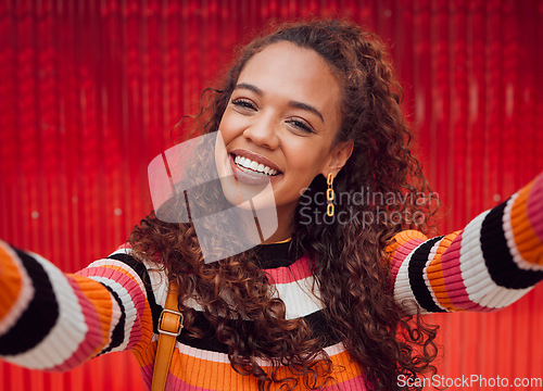 Image of Face, selfie and smile with a black woman happy against a red background while taking a photograph. Social media, fashion and beauty with an attractive young female posing for a picture outdoor