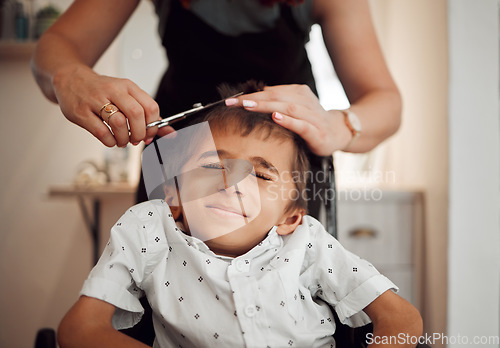 Image of Child with disability, hair cut and hands of hairdresser trim, groom and salon hair care service to young disabled kid. Barber studio, cerebral palsy and boy with handicap at haircut appointment