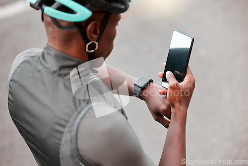 Image of Cycling, smartwatch and phone by man cyclist tracking cardio, pulse and health on an online app in a road. Sports, fitness and watch with black man cycling and monitoring progress, heart and wellness