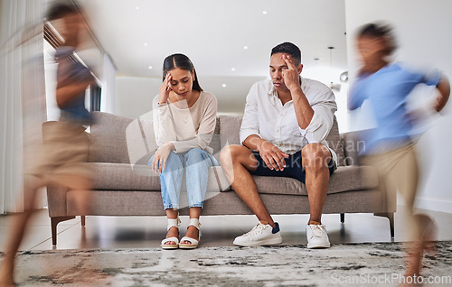 Image of Headache, kids running and parents on a sofa in a living room, suffering stress, anxiety and adhd children. Family, autism and burnout crisis with woman and man in mental health and energy problem