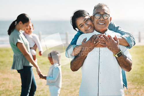 Image of Family, love and portrait of grandparents in park for summer, health and retirement together. Happy, lifestyle and bonding with children and old couple for smile, hug and bonding in outdoors