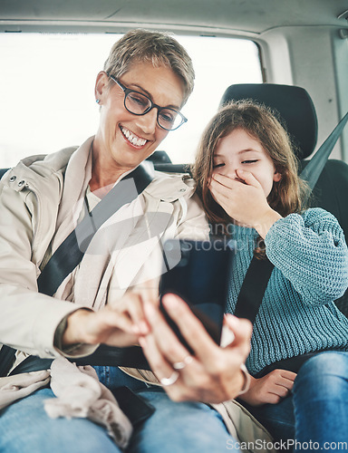Image of Phone, surprise and mother with child on car journey, travel or road trip for adventure, bond or fun quality time together. Love, shock or transport for kid girl with happy mom streaming online movie