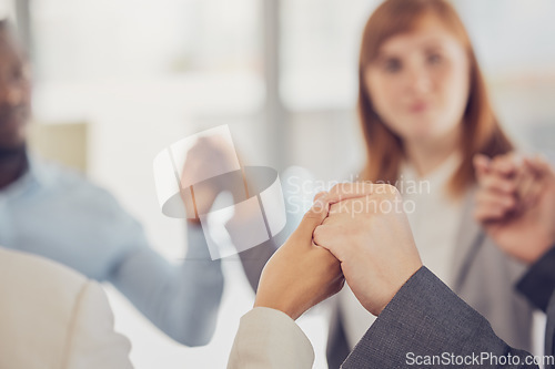 Image of Hands, support and trust with a business team in solidarity during a prayer meeting in their office. Collaboration, community and faith with a diversity group hand in hand in the boardroom at work