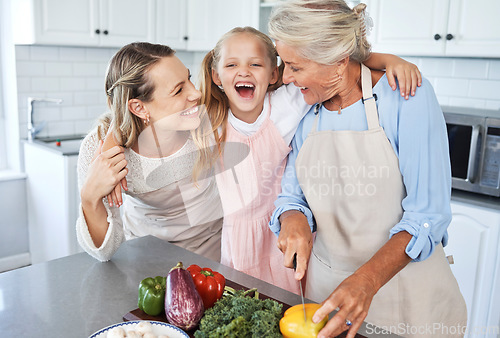 Image of Mother, grandma and child cooking as as happy family in a house kitchen with organic vegetables for dinner. Grandmother, mom and young girl laughing, bonding and helping with healthy vegan food diet