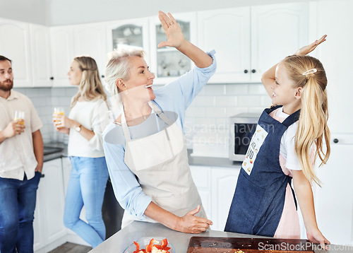 Image of High five, kitchen and cooking family or grandmother and child for success, learning achievement or home food health goal. Celebrate sign with senior woman and girl kid for support or help with lunch