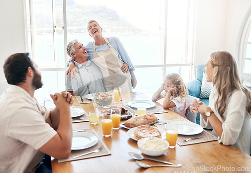 Image of Breakfast, communication and big family eating food together at the dining room table of their house. Senior man and woman speaking about funny story during lunch with children in their home