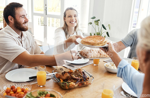 Image of Big family, lunch and food in home dining room with people sharing a meal. Love, happy and relatives eating food, bread and delicious gourmet chicken on table while spending quality time together.