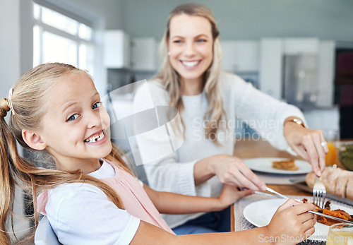 Image of Food, family and mother and daughter eating at a kitchen table, happy, relax and bonding in their home. Love, portrait and girl learning etiquette, nutrition and sharing meal with a cheerful parent