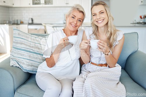 Image of Family, tea and love with a woman and senior mother sitting on the living room sofa together during a home visit. Coffee, happy and smile with a mature female and adult daughter bonding in a house