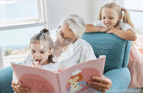 Image of Book, family and children with a grandmother and girl kids reading a story in a home living room together. Retirement, love and learning with an elderly female and sister siblings bonding in a house