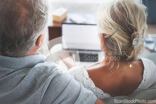 Image of Couple, retirement and pensioner with a senior man and woman watching tv on a laptop in their living room together. Love, entertainment and bonding with an elderly husband and wife streaming online