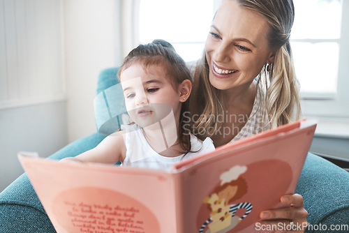Image of Book, family and love with a mother and daughter reading a story on a couch in the living room of their home together. Children, love and education with a woman and daughter bonding over a storybook