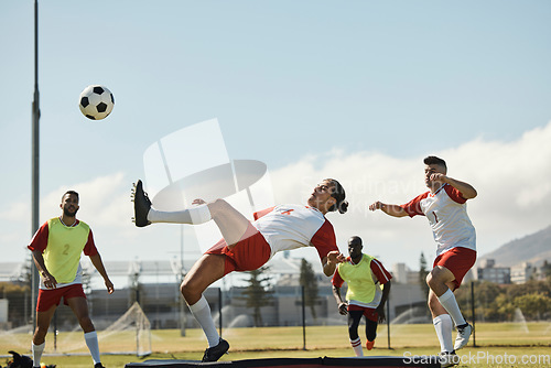 Image of Sports, soccer and soccer player with team and soccer ball in power kick while playing on soccer field. Energy, fitness and football with football players competing in training, exercise and practice