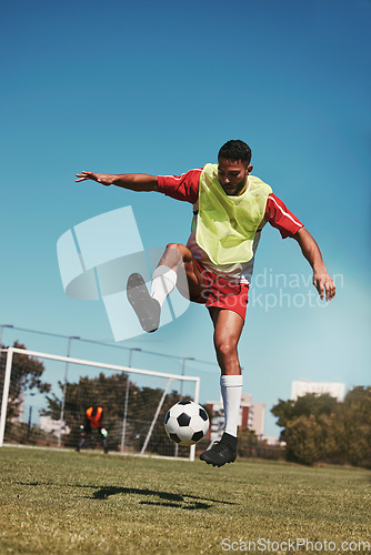 Image of Sport, fitness and soccer training with soccer player in soccer ball power kick on a soccer field, energy, exercise and passion. Sports, football and football player ball practice on football field