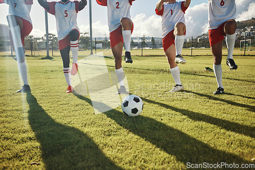 Image of Football, soccer field and team stretching legs preparing for match, practice or game. Ball, sports and group of men outdoors on pitch getting ready for training, exercise or fitness workout outside.