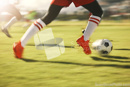 Image of Soccer, sports and running with the shoes of a man athlete on a grass pitch or field during a game. Football, fitness and training with a male player dribbling during a match or cardio workout