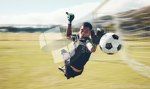 Image of Soccer, sports and goalkeeper with a man saving a shot, goal or score during a game on a grass pitch field. Fitness, football and training with a male athlete making a save during a practice session