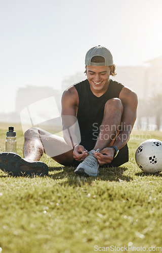 Image of Fitness, grass and man tie shoes on grass for football training, workout and sports exercise. Summer, energy and health with athlete with sneakers in city park for lifestyle, wellness and soccer ball