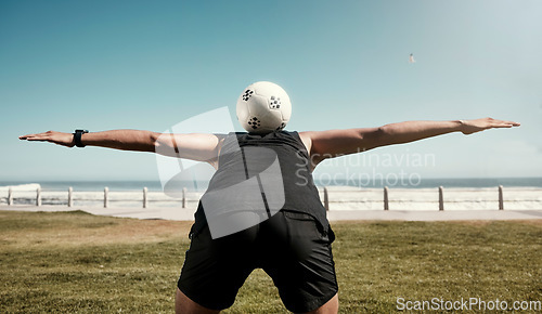 Image of Soccer ball, balance back and sports training of a man athlete at the beach for a workout. Exercise, fitness and health cardio of a person on a field by sea water, ocean and nature in summer