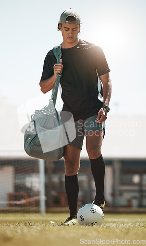 Image of Football, training and exercise man with ball on sport field after training, practice and workout with bag. Athlete, soccer and fitness on sports ground after healthy sports cardio outdoor in summer