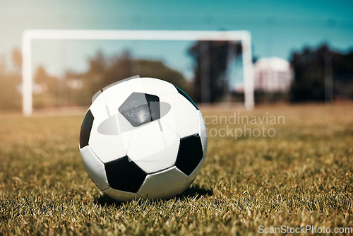 Image of Sports, soccer ball and soccer field for training, fitness and kick practice exercise, wellness and summer fun. Football, ball and football field ground during day for workout, speed and challenge