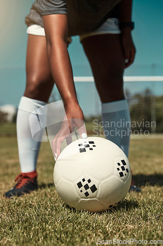 Image of Hand, placing and soccer ball on field for free kick, penalty or goal in game, training or match. Woman, football and grass outdoor in summer for fitness, exercise and workout in sports for wellness